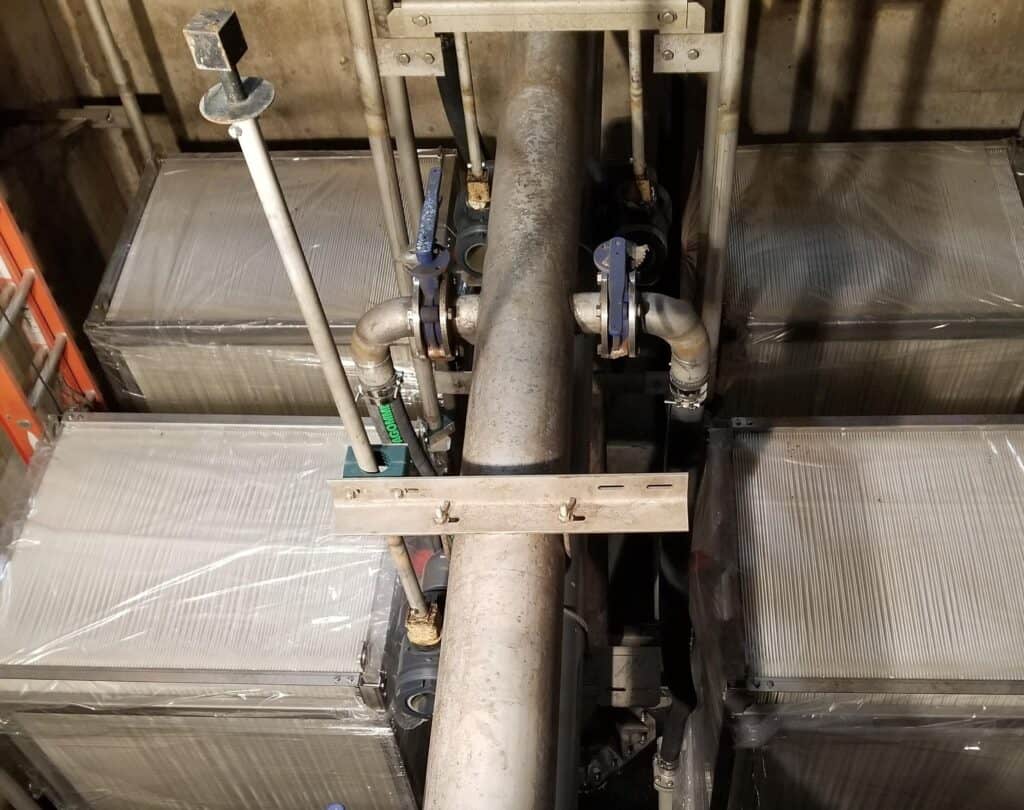 High-capacity industrial water treatment system with large metal tanks and piping for efficient filt.