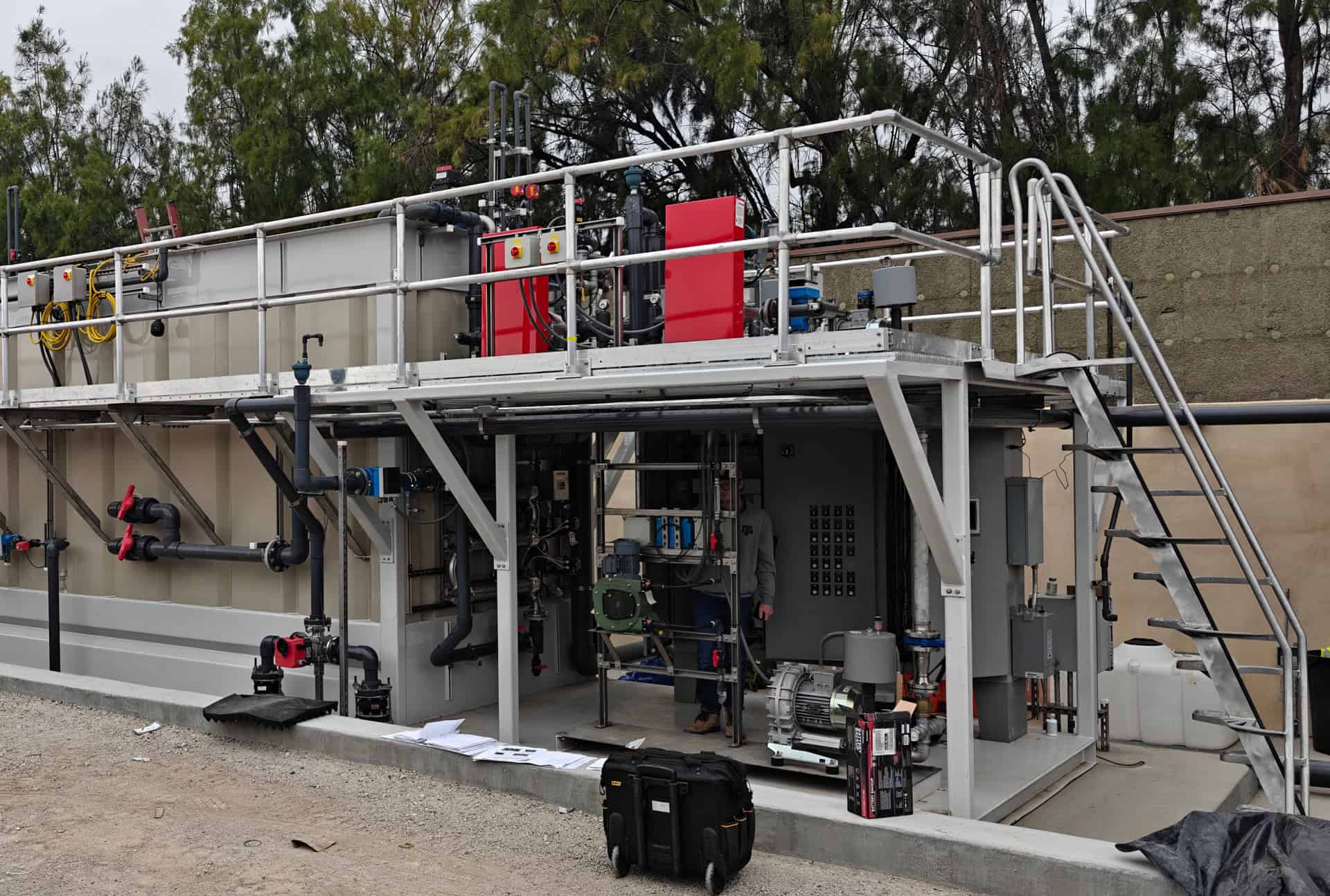 Industrial MBR system for wastewater treatment with control panels and piping.