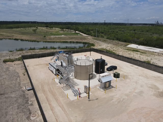 Modular wastewater treatment plant with tanks and equipment in an open area.