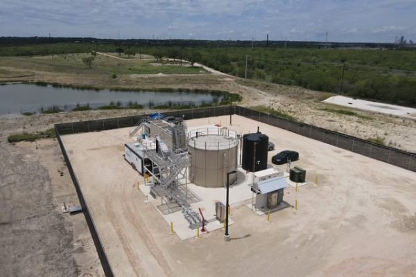Modular wastewater treatment plant with tanks and equipment in an open area.
