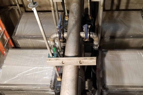 High-capacity industrial water treatment system with large metal tanks and piping for efficient filt.